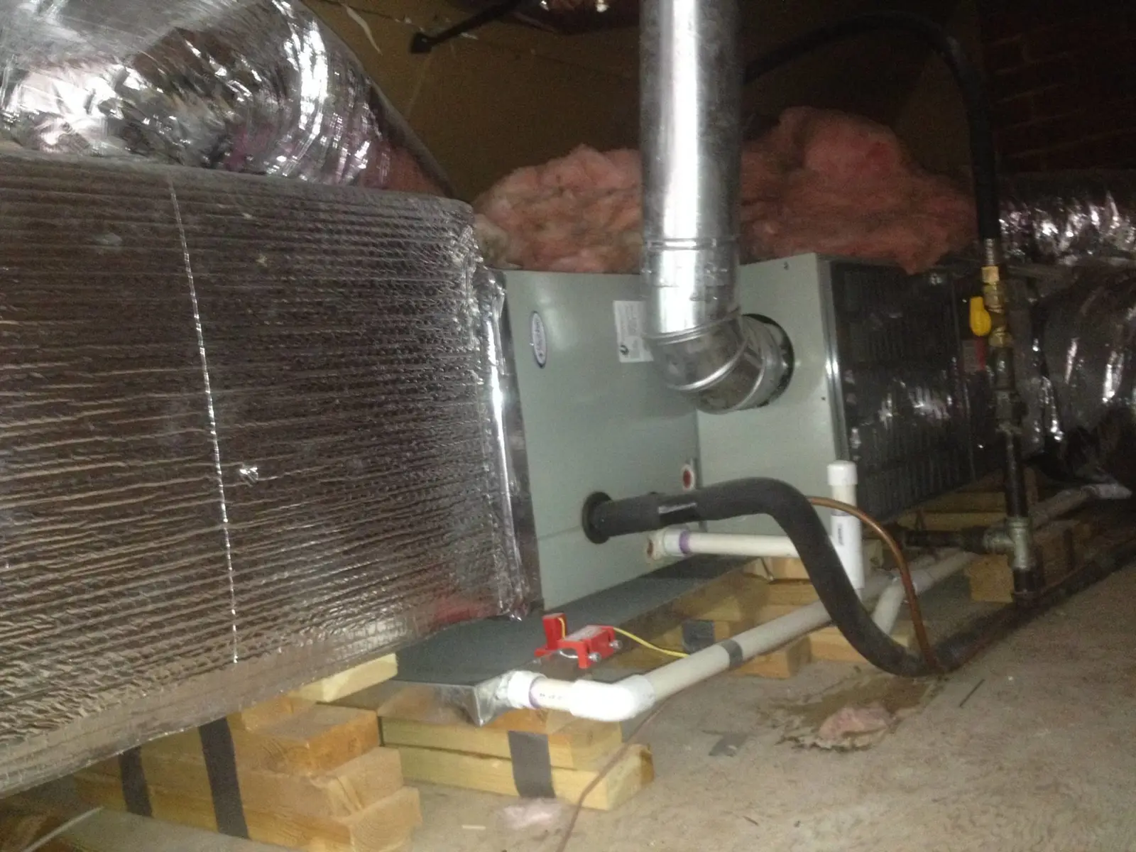 Ground Up Foundation Repair, Waterproofing and Concrete Leveling inspecting standing water and HVAC unit in a damp crawl spac