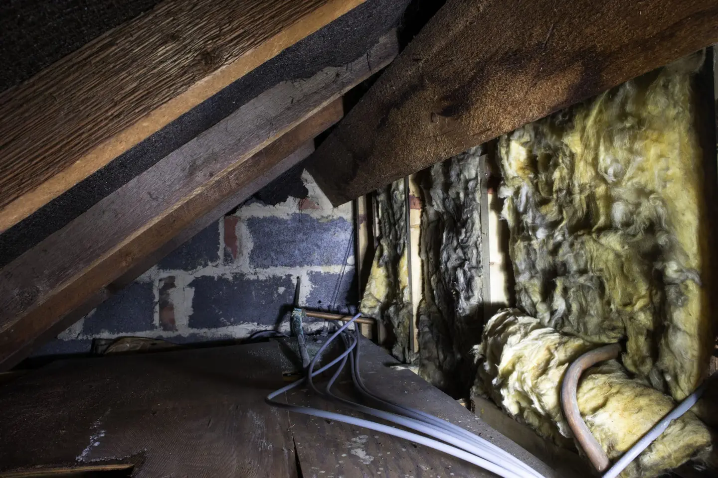 Ground Up Foundation Repair, Waterproofing and Concrete Leveling inspecting deteriorating insulation with mold and moisture