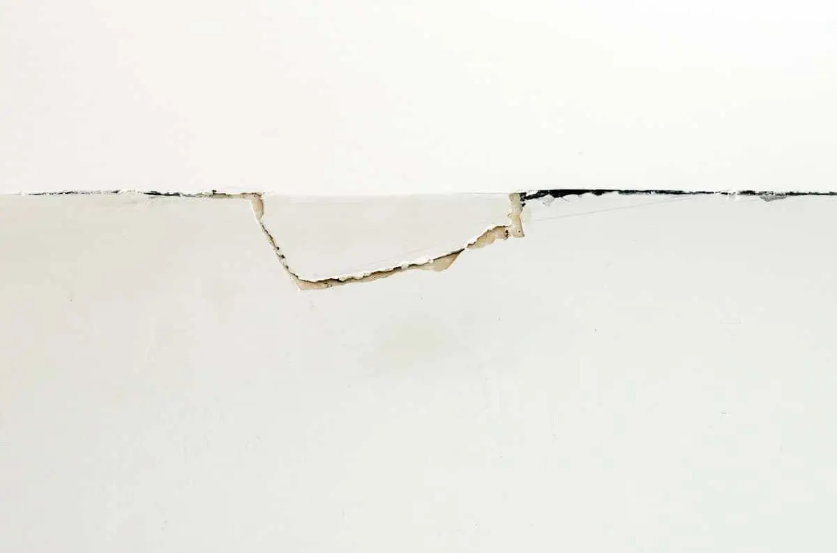Ground Up Foundation Repair, Waterproofing and Concrete Leveling inspecting a diagonal drywall crack where a wall meets