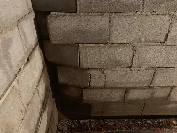 A severely bowing concrete block basement wall.