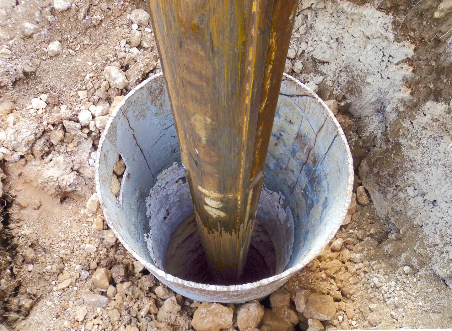 Ground Up Foundation Repair, Waterproofing and Concrete Leveling installing a square shaft steel pier for foundation