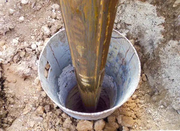 Ground Up Foundation Repair, Waterproofing and Concrete Leveling installing a square shaft steel pier for foundation