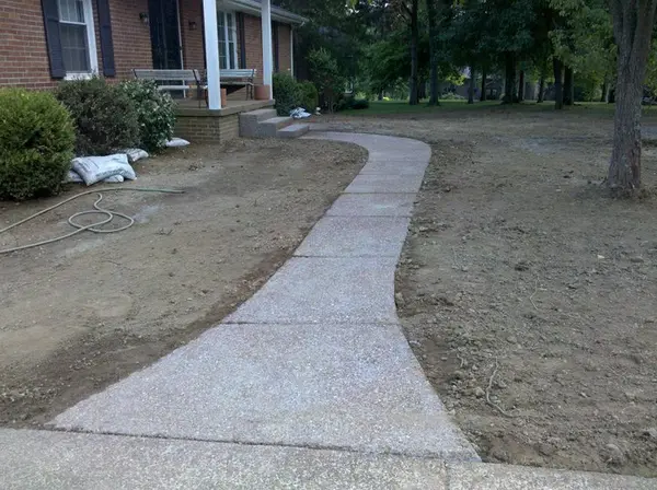 Ground Up Foundation Repair, Waterproofing and Concrete Leveling installing a new curved concrete sidewalk.