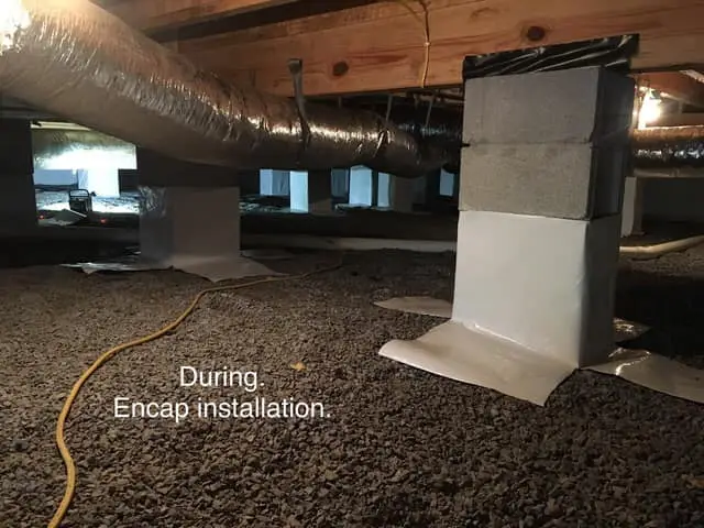 Ground Up Foundation Repair, Waterproofing and Concrete Leveling installing a crawl space vapor barrier around support piers.