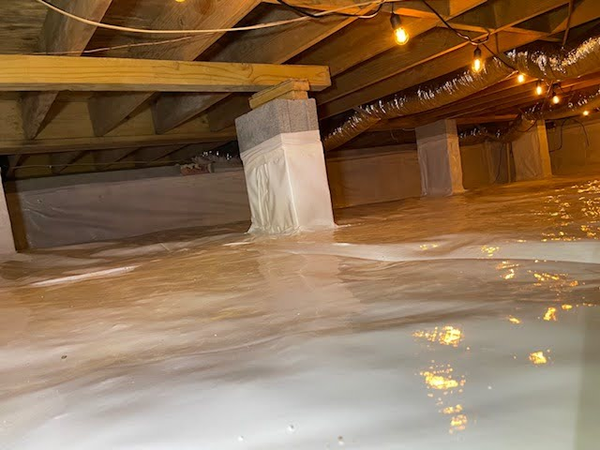 A clean white vapor barrier in an encapsulated crawl space.