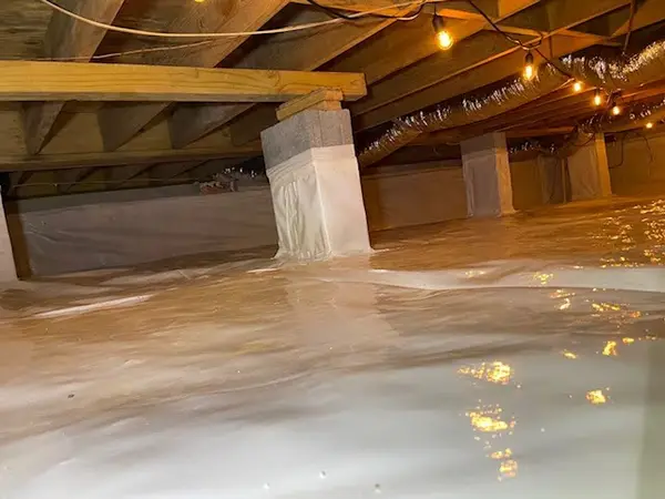 Ground Up Foundation Repair, Waterproofing and Concrete Leveling installing a crawl space vapor barrier and encapsulation