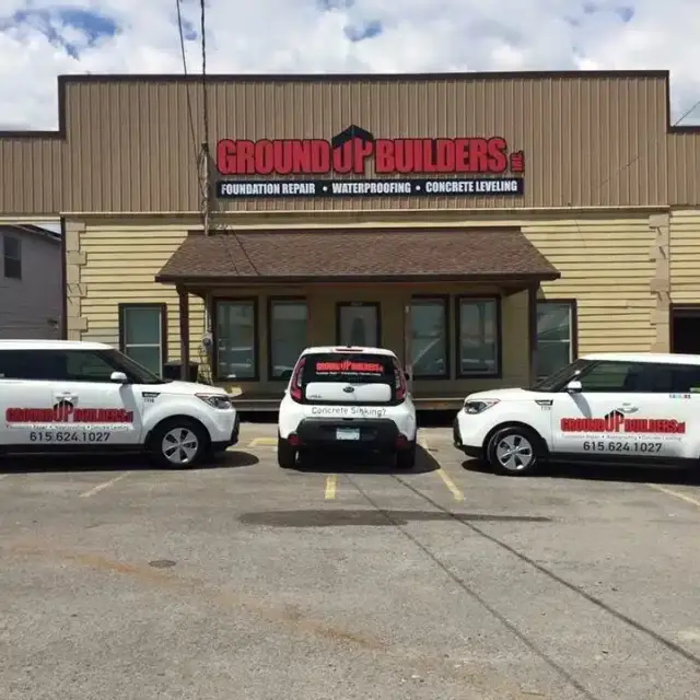 Ground Up Foundation Repair, Waterproofing and Concrete Leveling, showing branded fleet vehicles parked outside the company