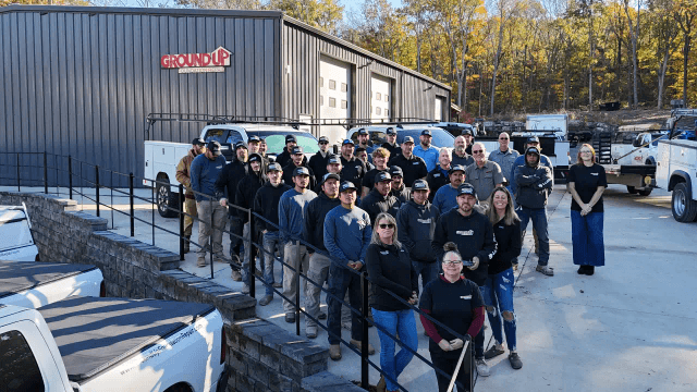 Ground Up Foundation Repair team members outside the company office with their service trucks.