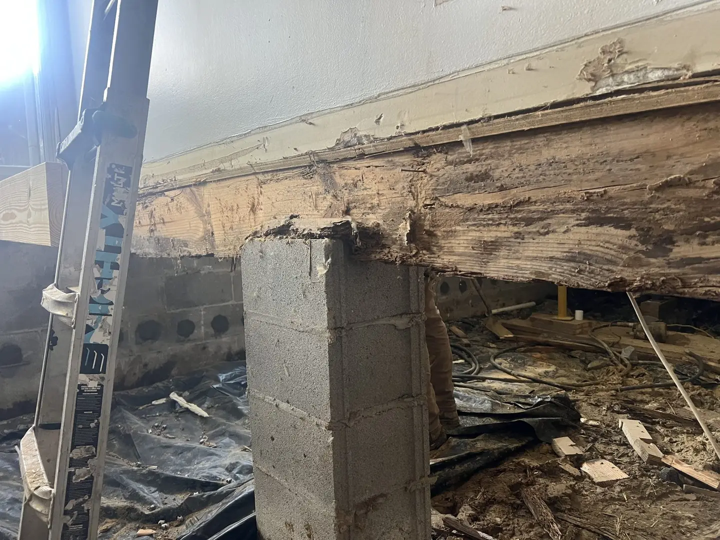 Ground Up Foundation Repair, Waterproofing and Concrete Leveling repairing rotted wood beam and block pier in a crawl space.