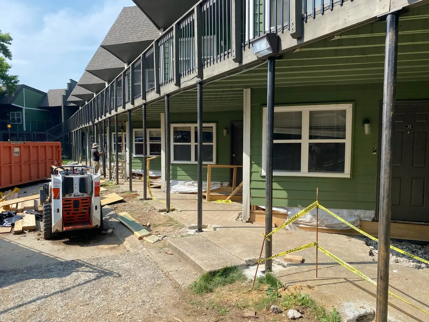 Ground Up Foundation Repair, Waterproofing and Concrete Leveling repairing steel support posts under an apartment deck.