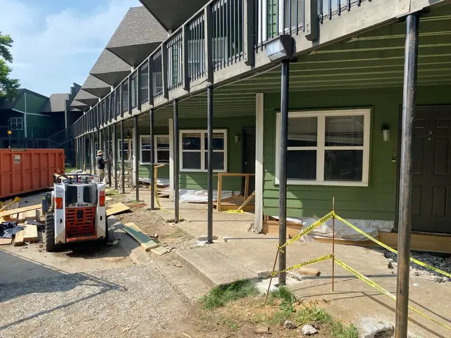Ground Up Foundation Repair, Waterproofing and Concrete Leveling repairing steel support posts under an apartment deck.