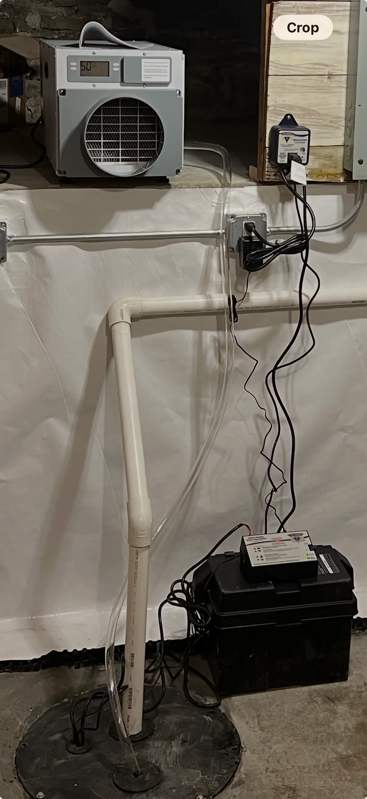 Ground Up Foundation Repair, Waterproofing and Concrete Leveling installing a backup sump pump and dehumidifier