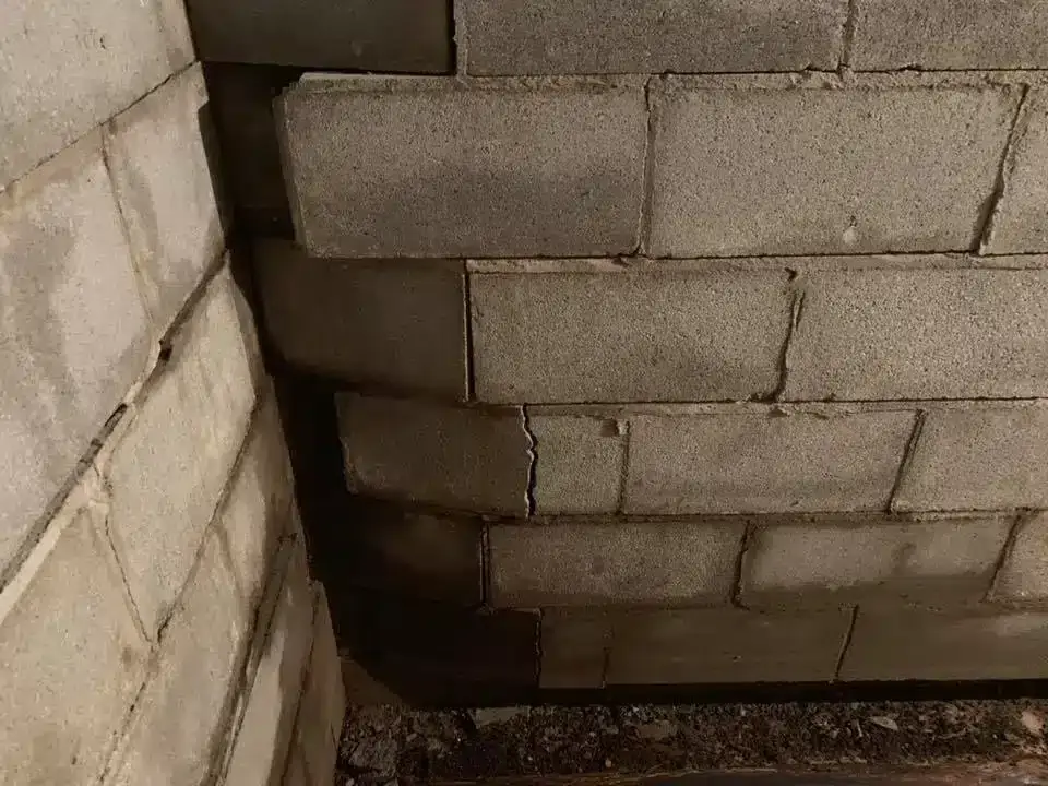 Ground Up Foundation Repair, Waterproofing and Concrete Leveling inspecting a bowing basement foundation wall