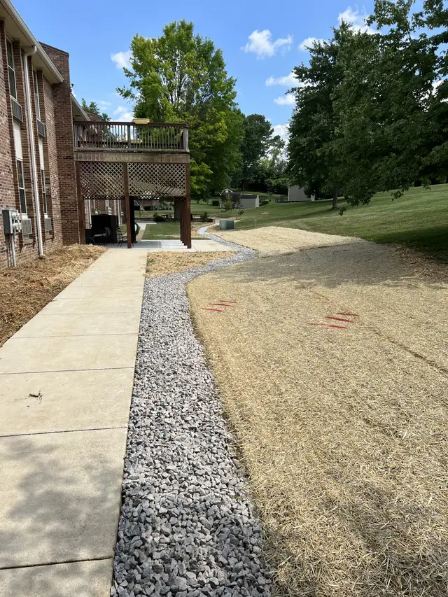 Ground Up Foundation Repair, Waterproofing and Concrete Leveling installing yard drainage solutions with a gravel trench