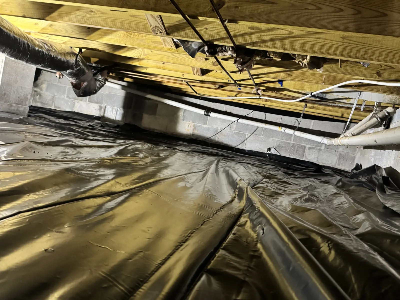 Ground Up Foundation Repair, Waterproofing and Concrete Leveling inspecting deteriorating insulation and existing ground